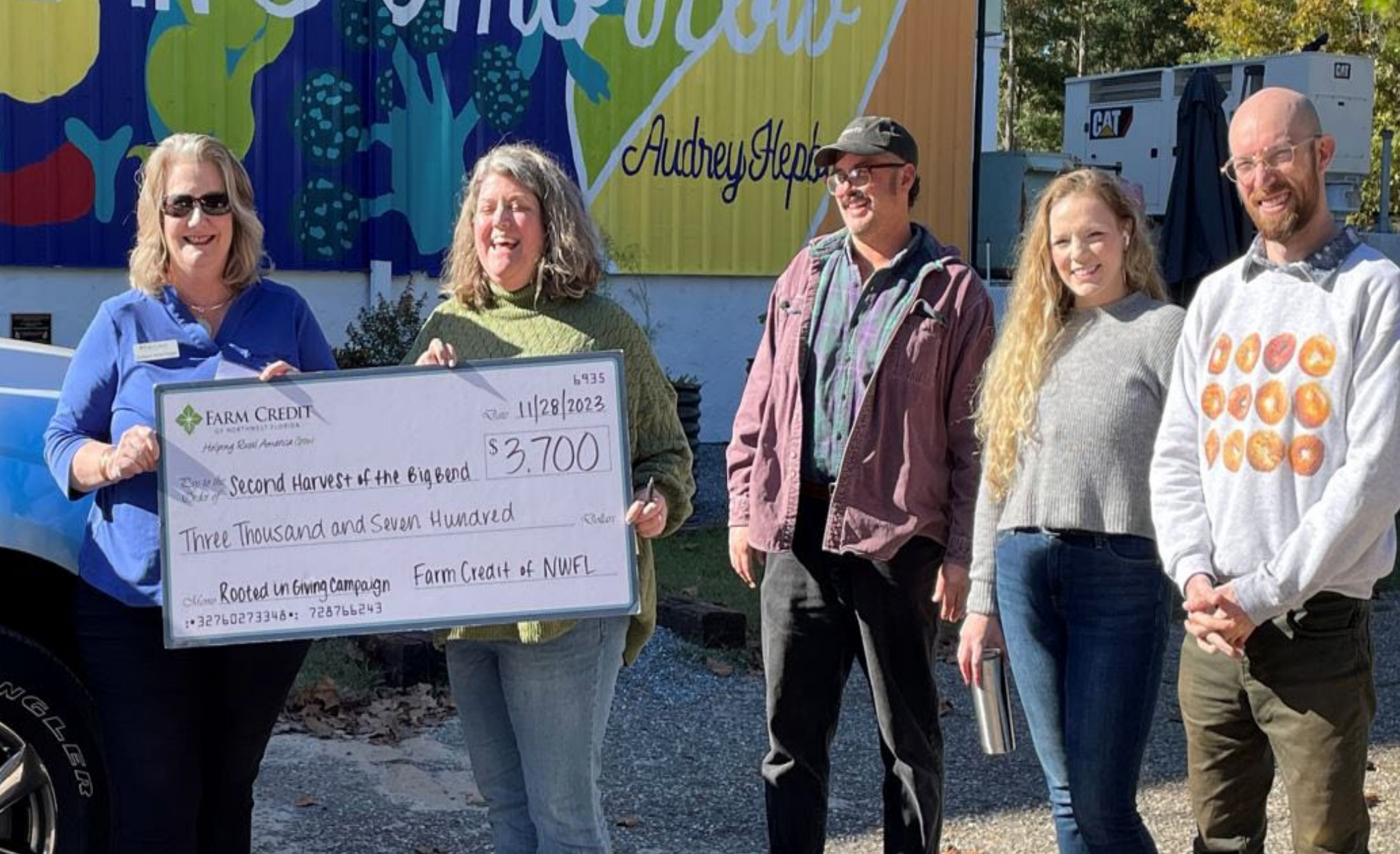 Rooted in Giving Donation Award to Kristie Teal, Donor Engagement Manager of Second Harvest of the Big Bend by Farm Credit of Northwest Florida, Director of Human Resources, Dorislynn White-Padgett.